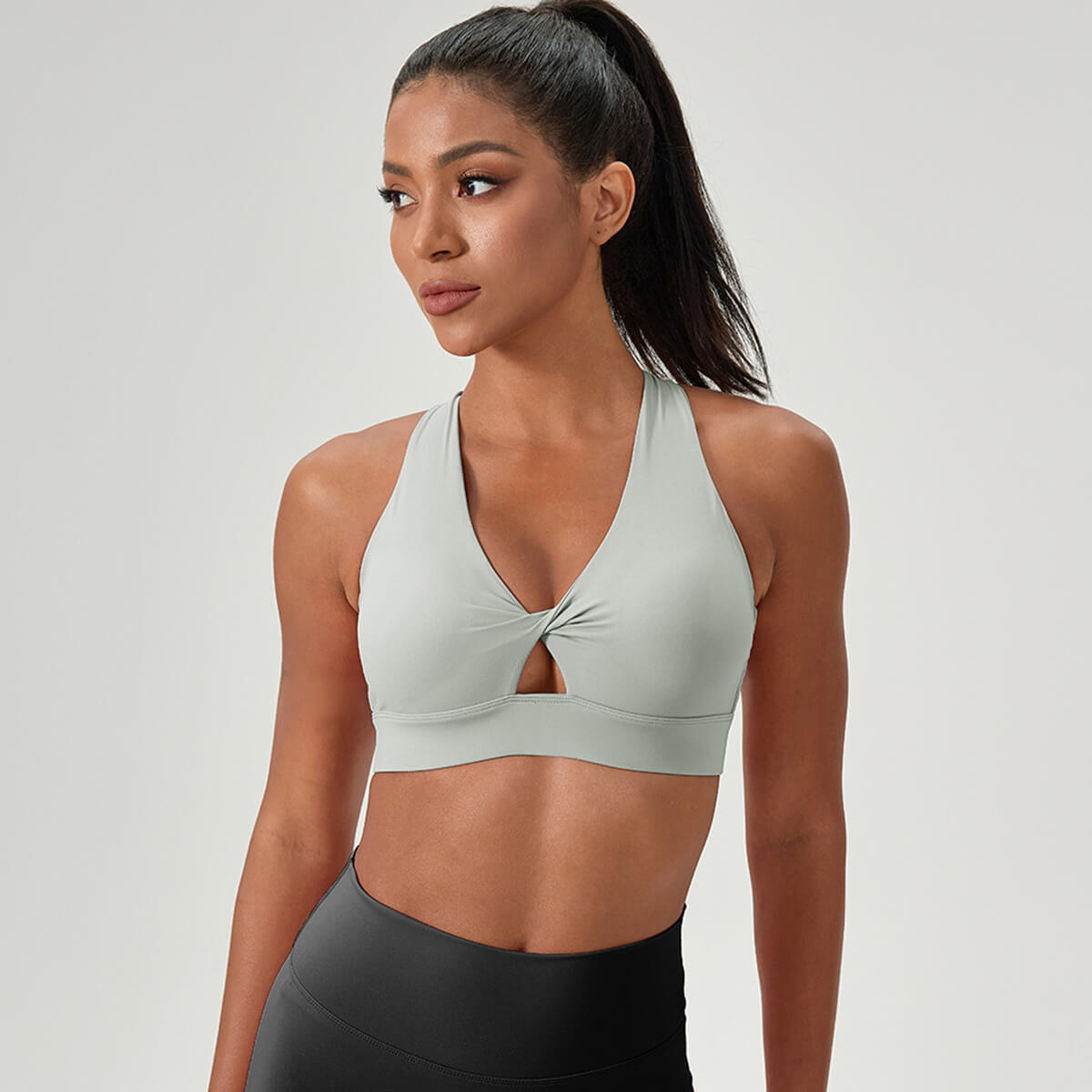 Gray activewear bra featuring a cross-front design and breathable fabric.