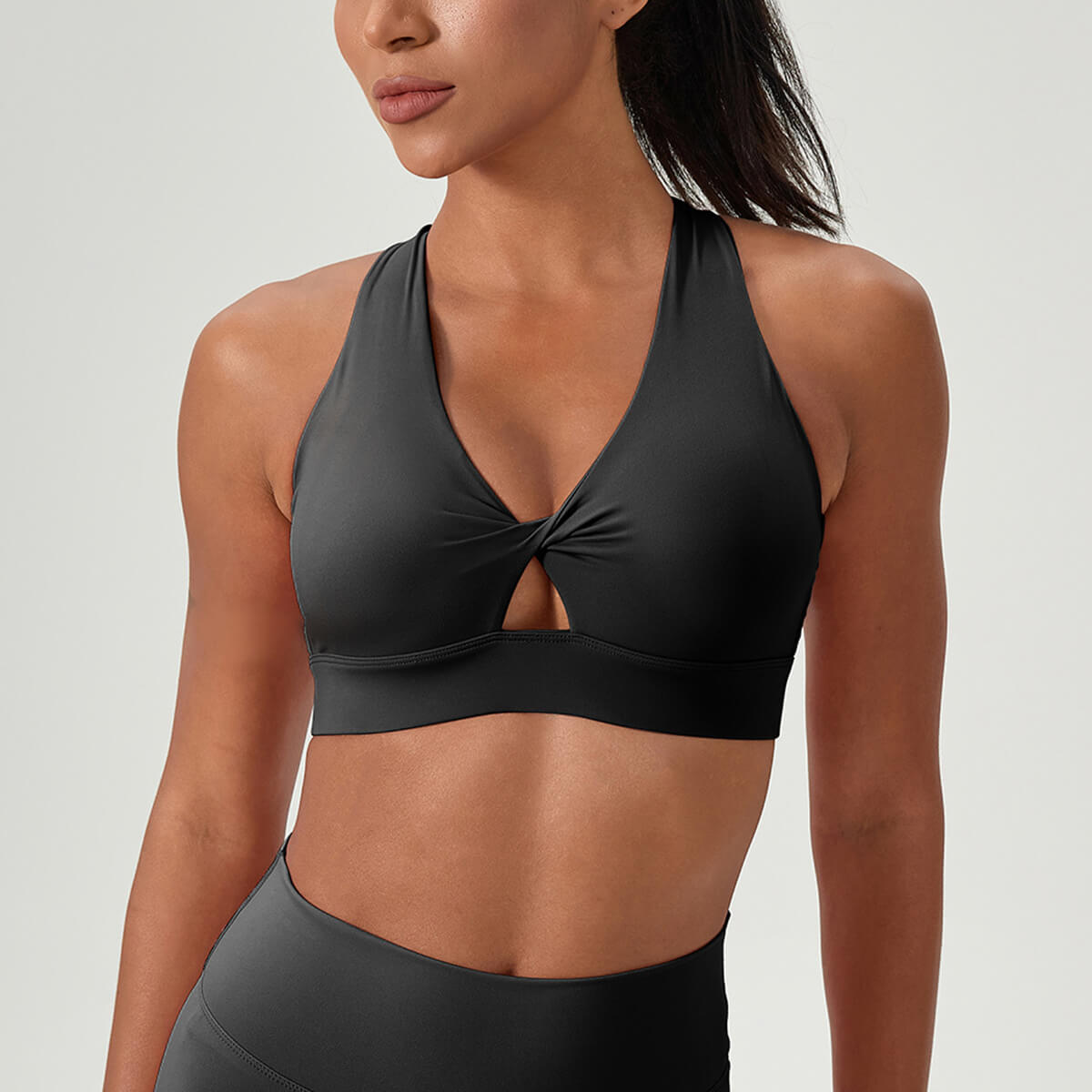 Black sports bra with a criss-cross front design for gym and fitness workouts.