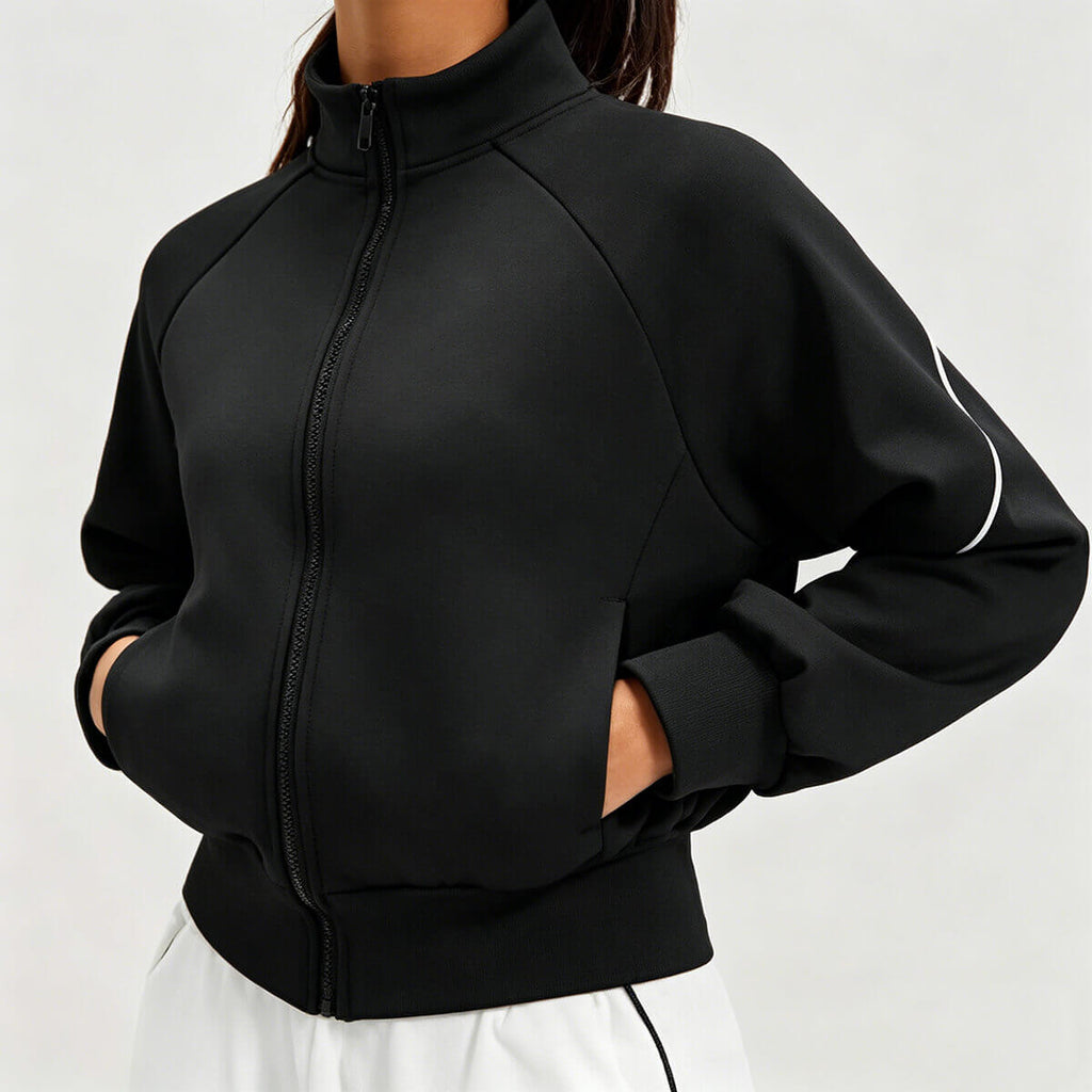 Side view of a black full-zip yoga jacket with side pockets and ribbed cuffs, designed for high-performance training and running.