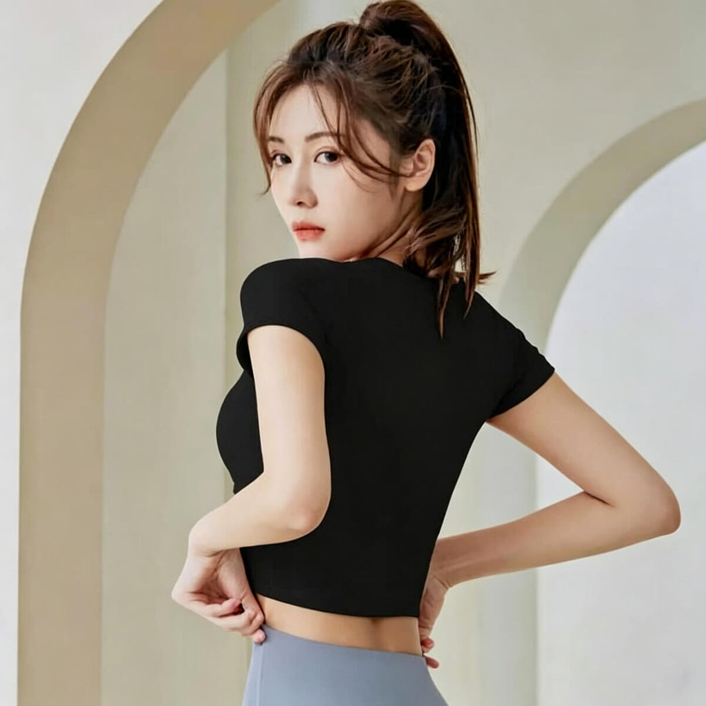 Back and side profile of a classic black yoga crop top with a unique hollow-out collar detail, ideal for gym workouts.