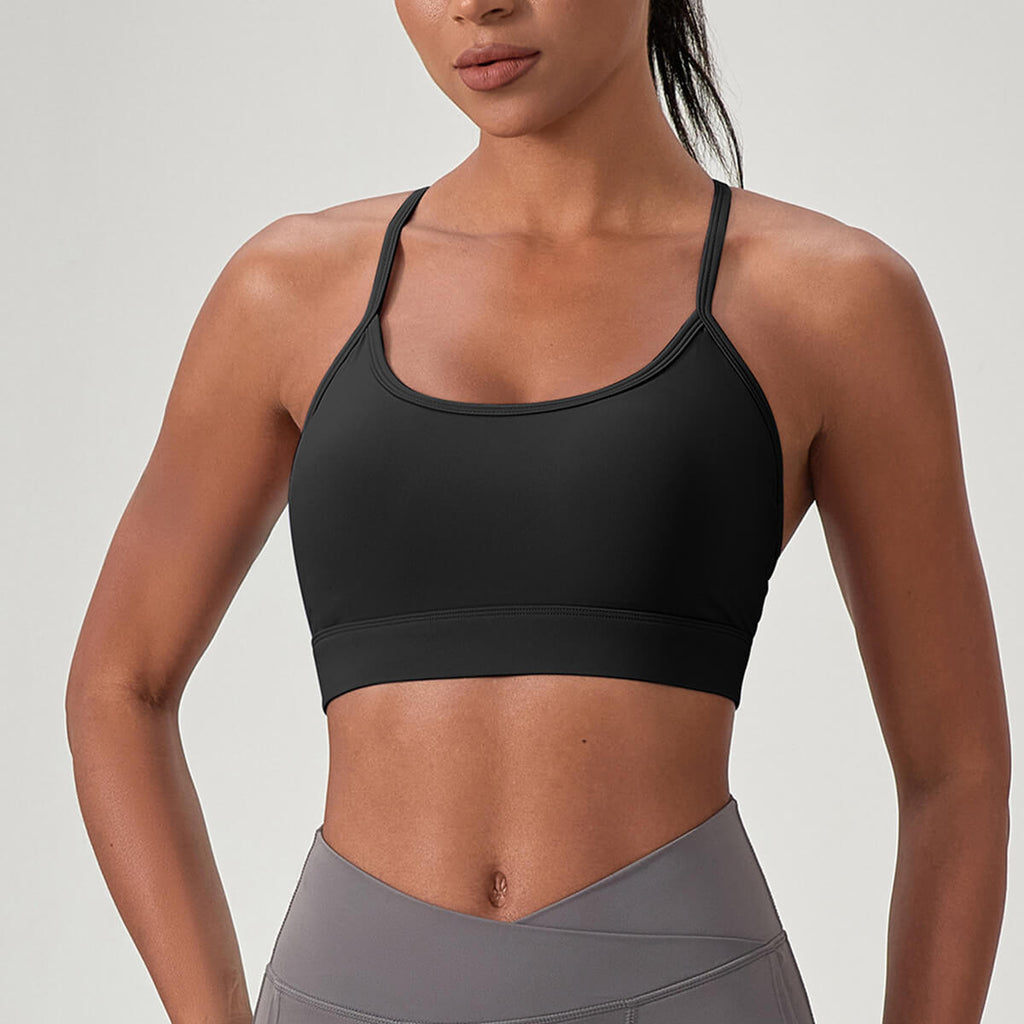 Front view of a woman wearing a black high-impact sports bra with a classic scoop neckline and wide supportive underband.