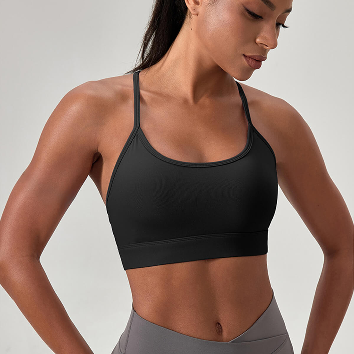 Close-up of a form-fitting black sports bra made of moisture-wicking fabric, designed for gym training and yoga.