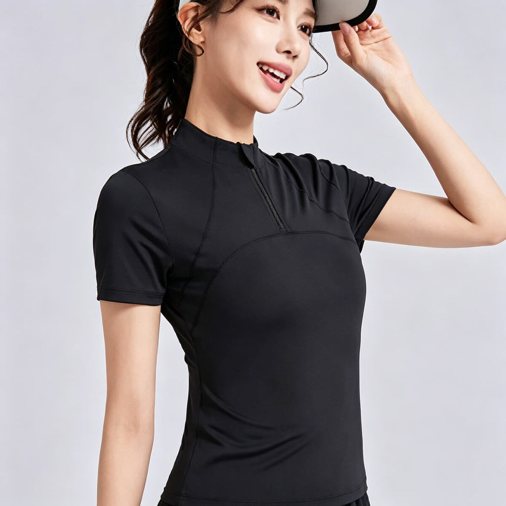 Close-up of the adjustable half-zip mock neck and stand-up collar on a women's black performance gym top