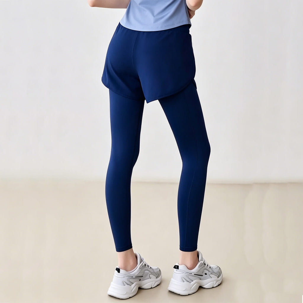 Rear view of blue fake two-piece fitness leggings showing high-waist cut and functional outer shorts coverage