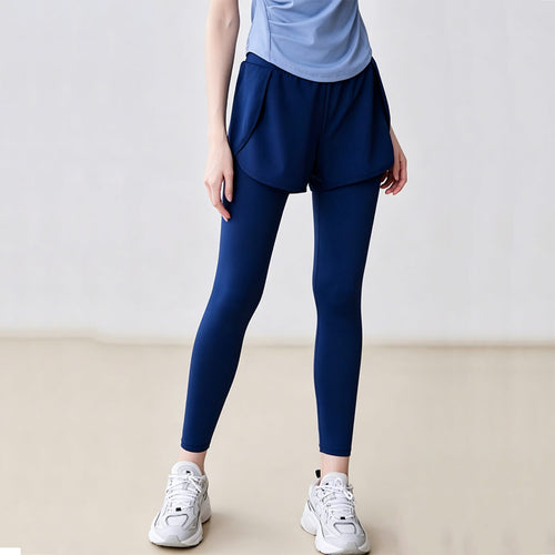 Front view of blue 2-in-1 sports leggings featuring loose outer shorts over slim-fit inner tights for running and gym