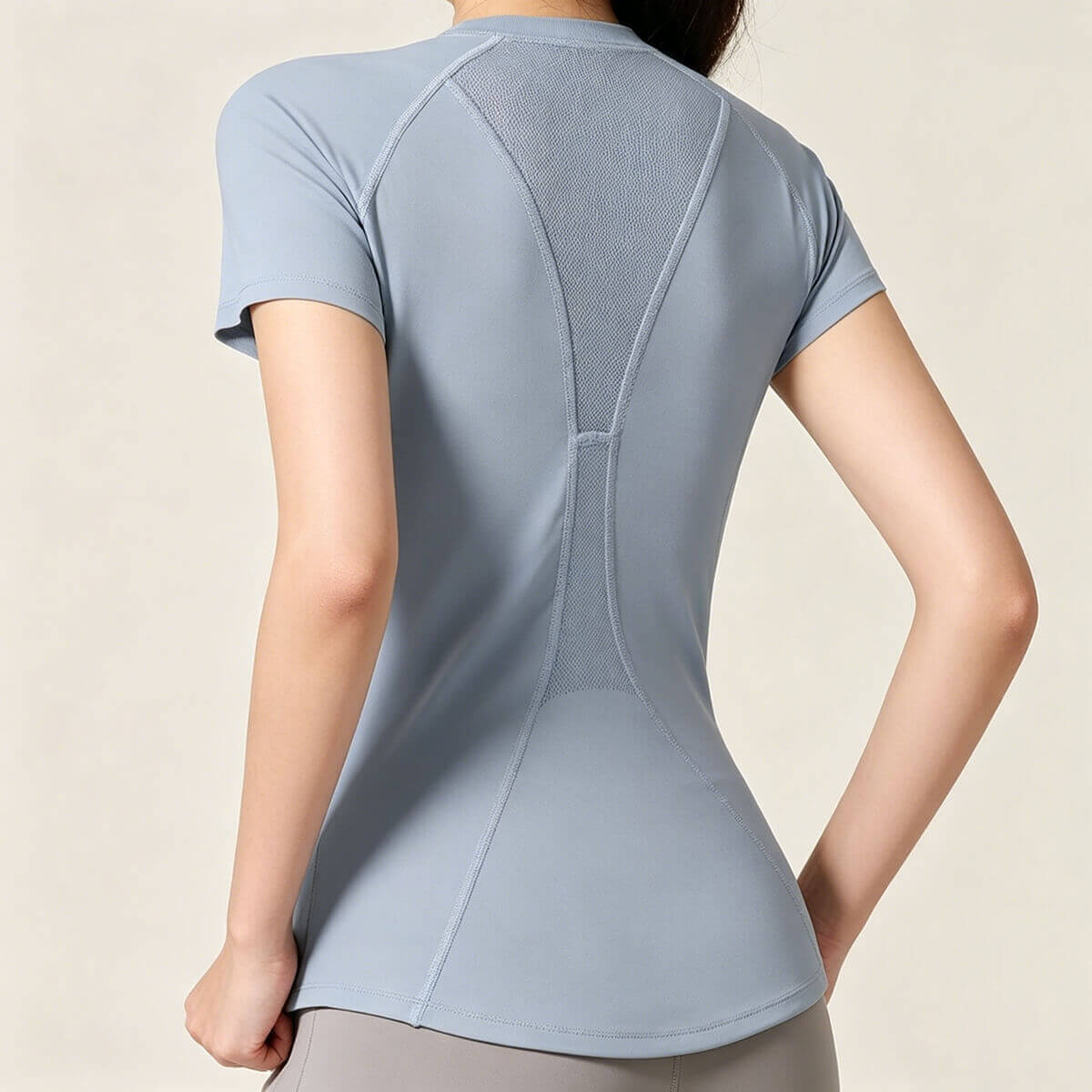Light blue women's athletic top showing the stylish mesh back design for enhanced breathability during high-intensity training.