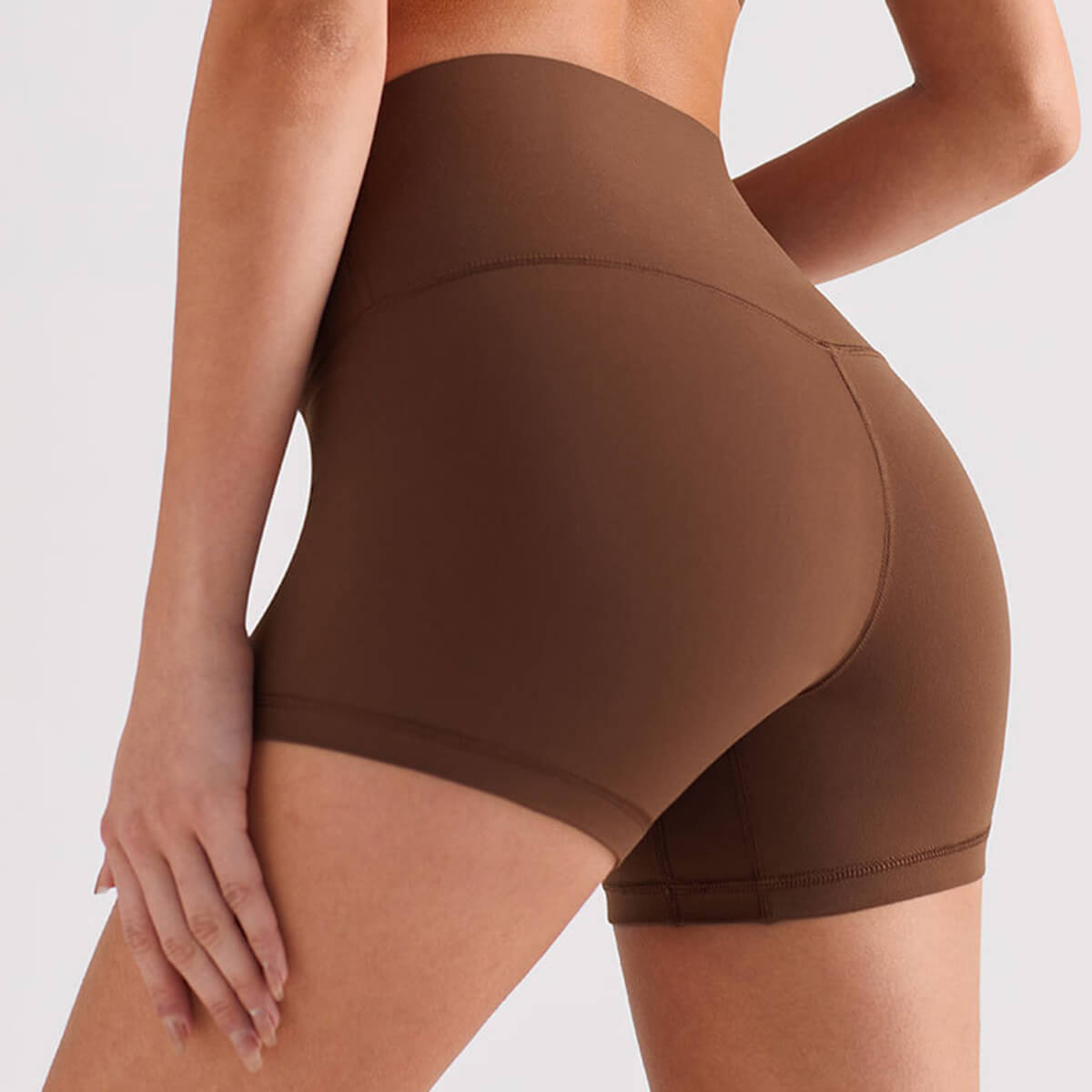 Back view of brown high waisted butt lifting workout shorts for gym.