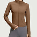 Front view of a women's slim-fit fleece-lined athletic jacket in coffee brown, featuring a full-zip front and mock neck for winter workouts