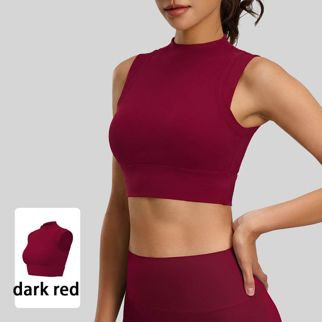 Front close-up of a deep burgundy red high-neck sleeveless yoga crop top with supportive seamless fabric and a clean-finished hem