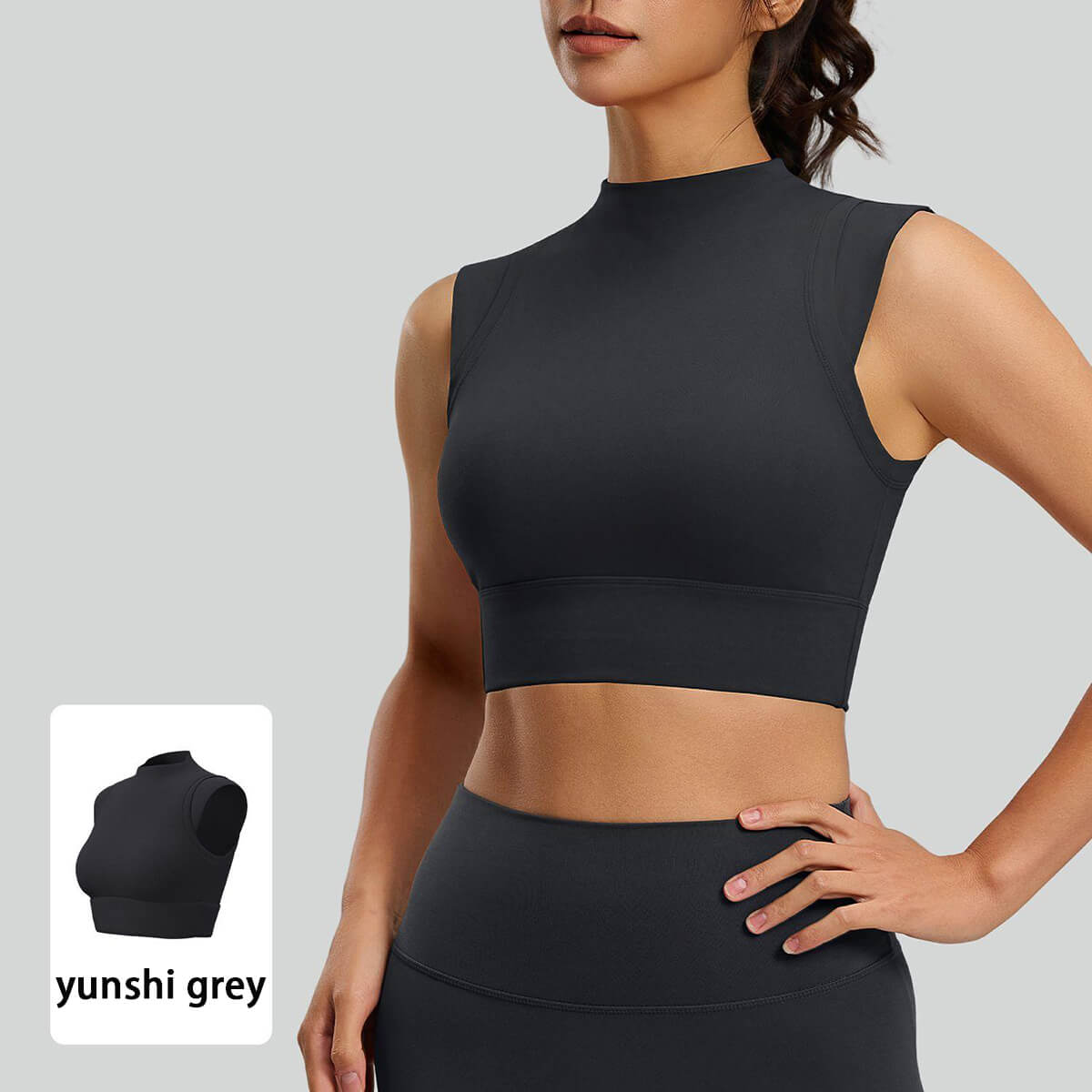 Front close-up of a charcoal grey mock neck athletic crop top featuring a wide elastic under-bust band for medium-impact gym workouts