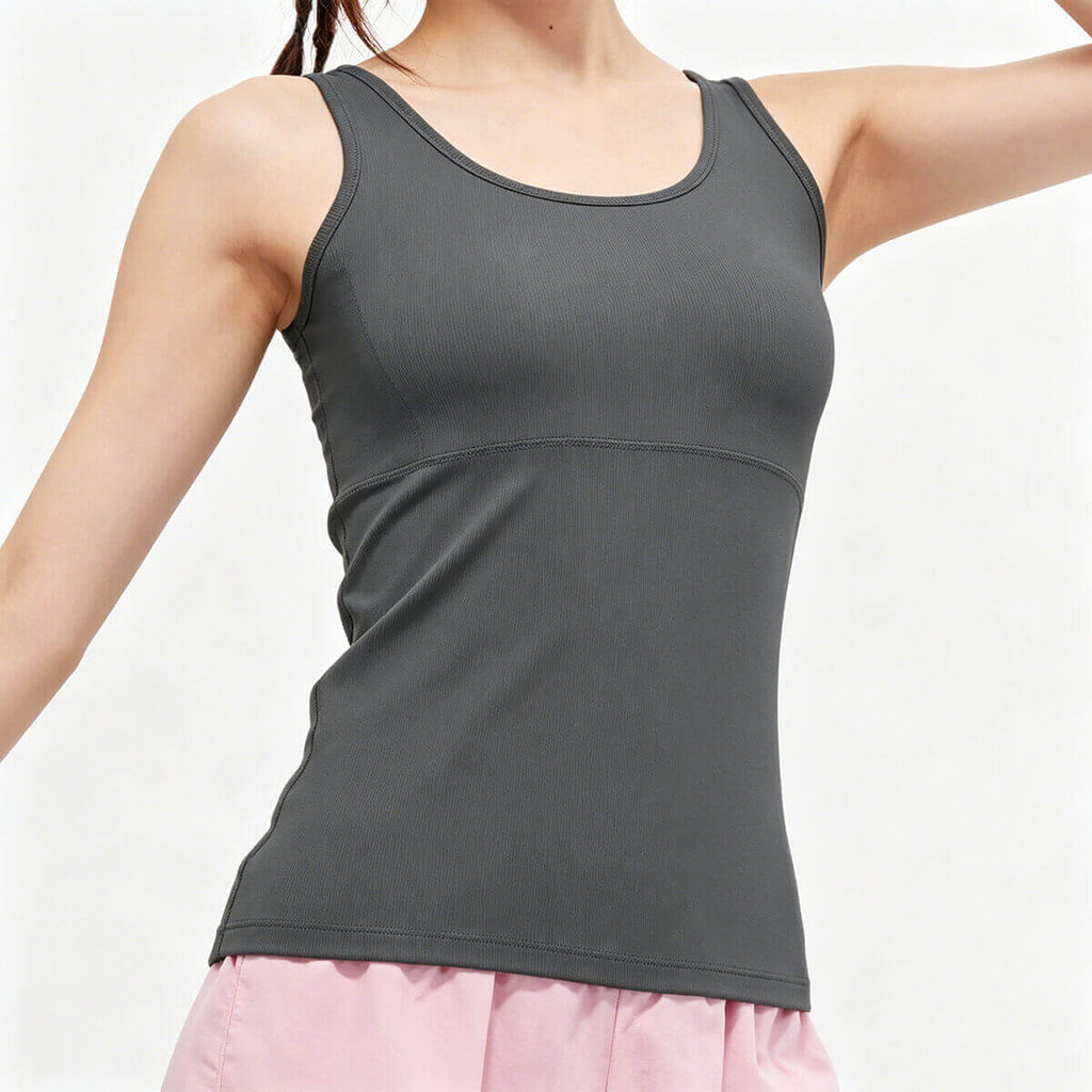 A woman modeling a charcoal gray workout tank top with wide comfortable straps and a slim-fit design for gym and fitness