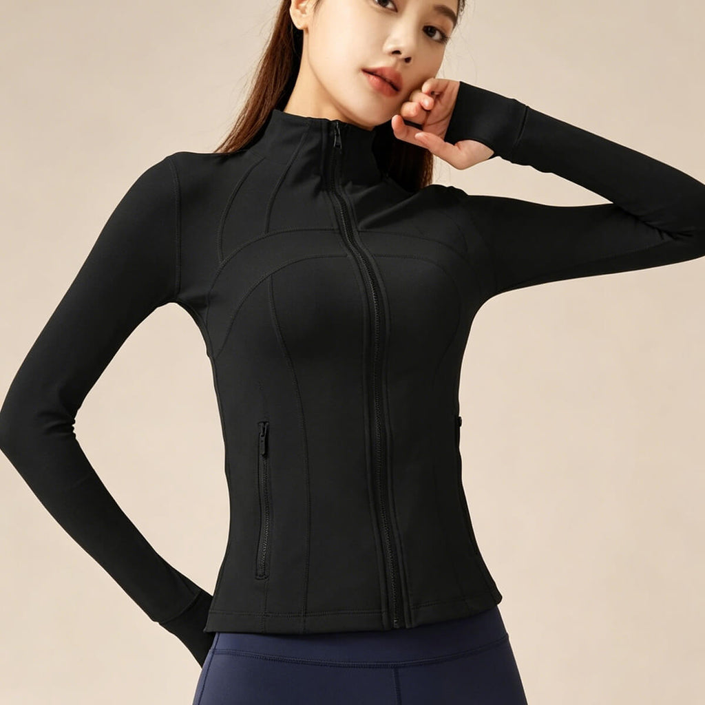 A model wearing a classic black full-zip yoga jacket with a high neck and sleek silhouette, perfect for gym and athleisure