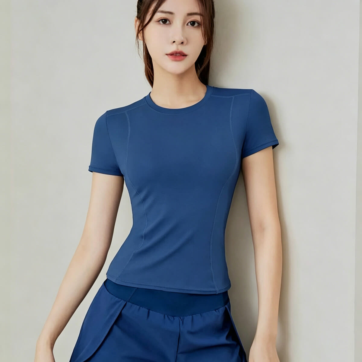 Cobalt blue moisture-wicking fitness tee for women with strategic seams that trace natural lines for a flattering shape.