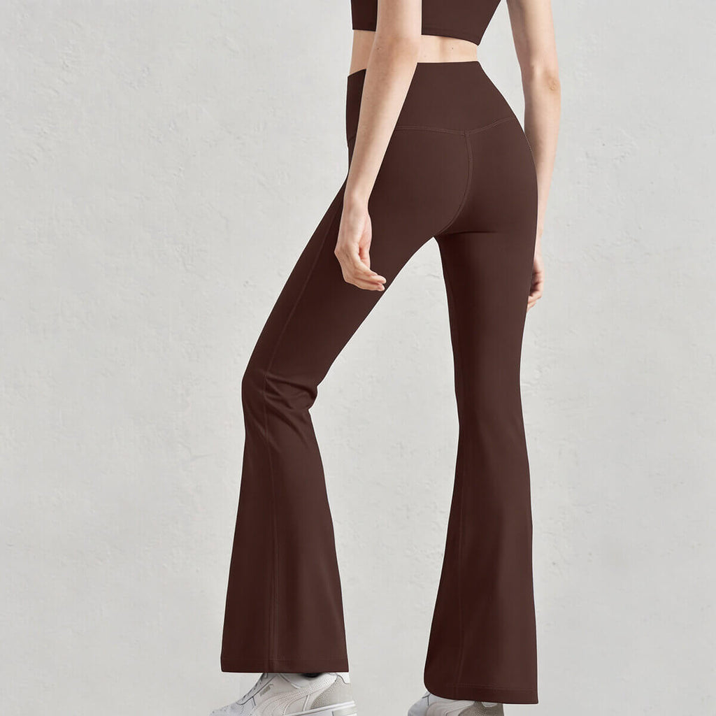 Rear profile of coffee bootcut yoga leggings with a V-contoured back seam to enhance the glutes.