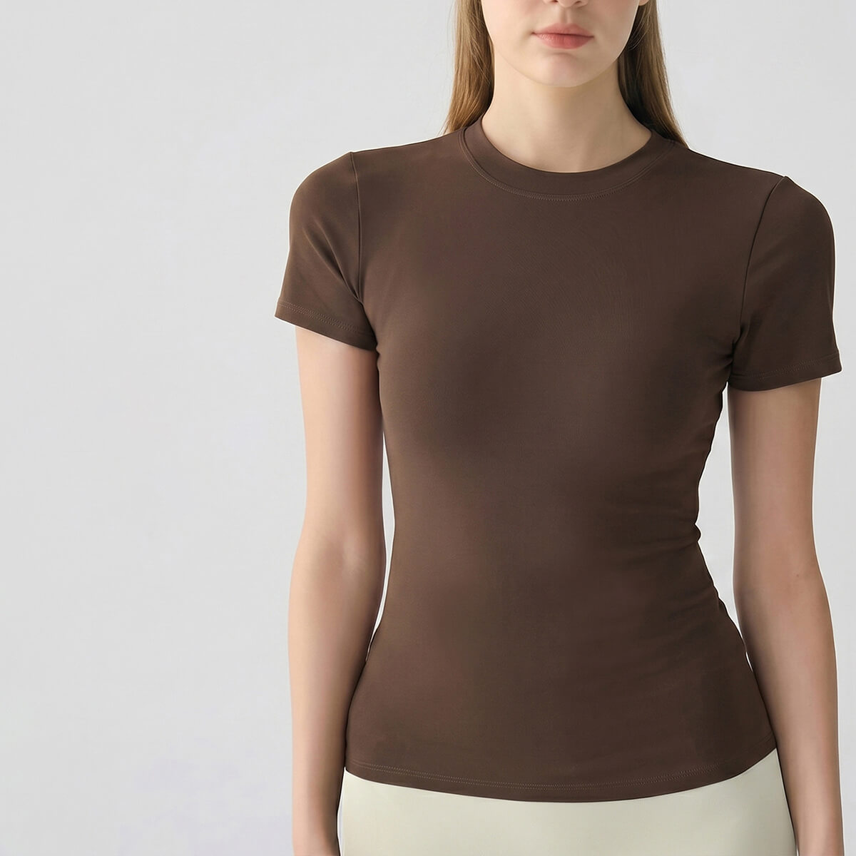 A coffee brown buttery-soft yoga tee for women, designed with a body-hugging fit for maximum comfort.