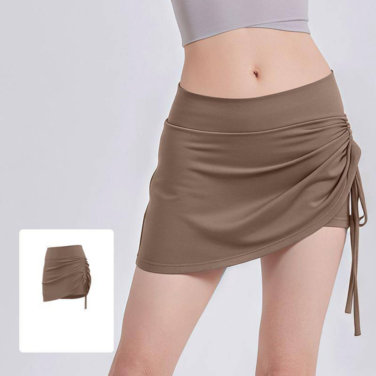 Trendy coffee brown cross-over athletic skort with side drawstring, perfect for golf, tennis, and summer athleisure.