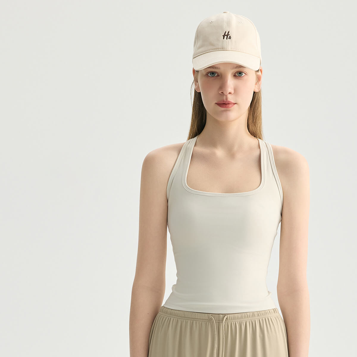 Front view of a cream white square-neck camisole tank top, ideal for studio-to-street wear.