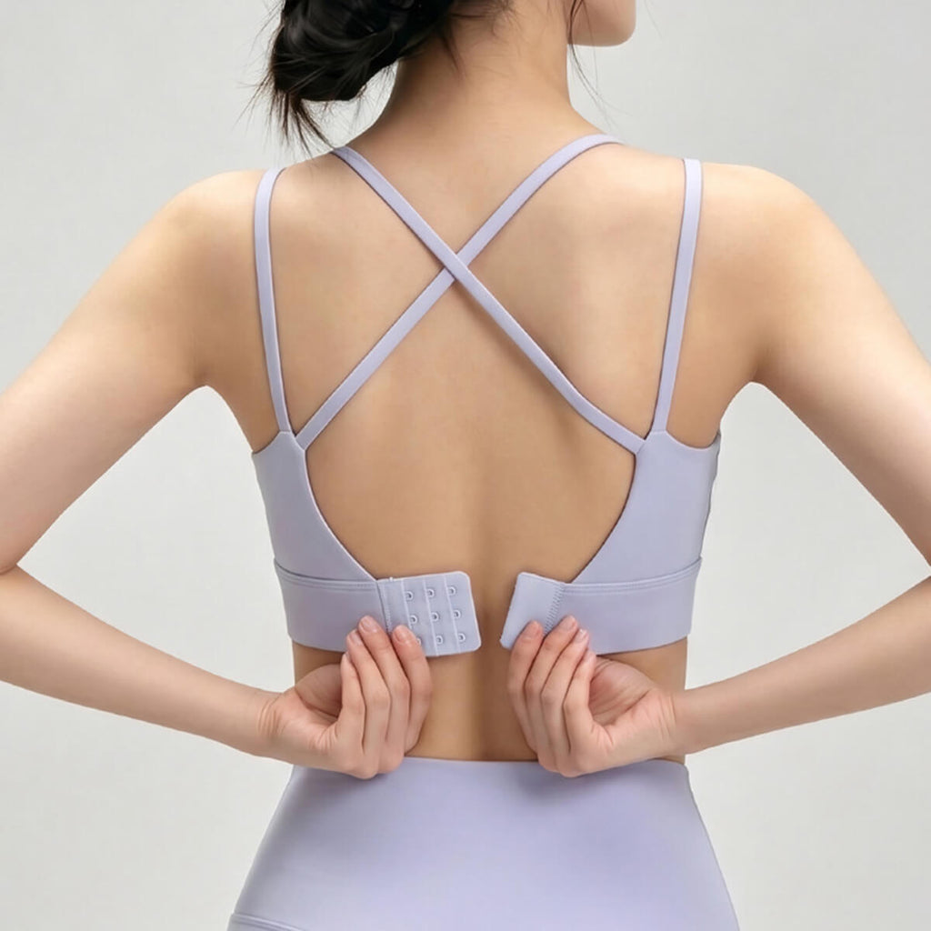 Back view of purple sports bra with criss-cross straps and hooks.