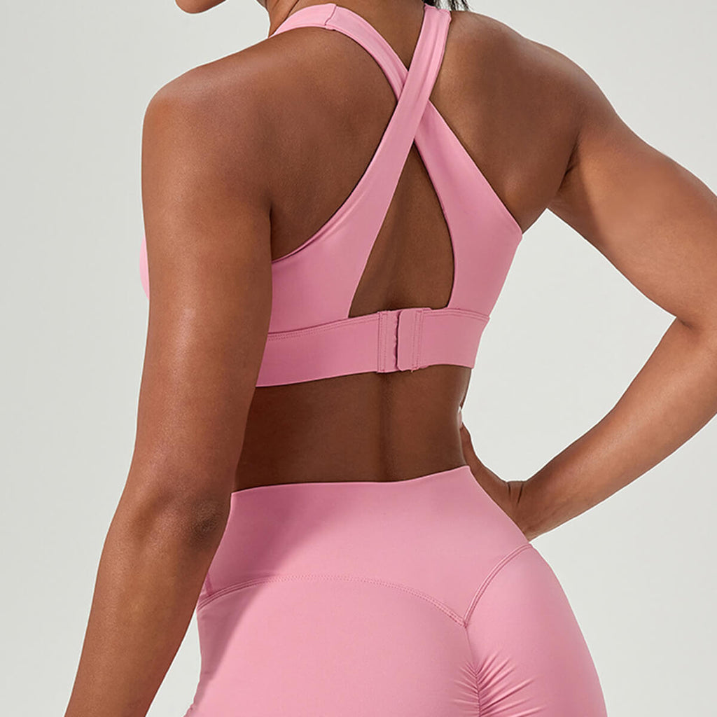 Back view of pink criss-cross sports bra with adjustable hook-and-eye closure