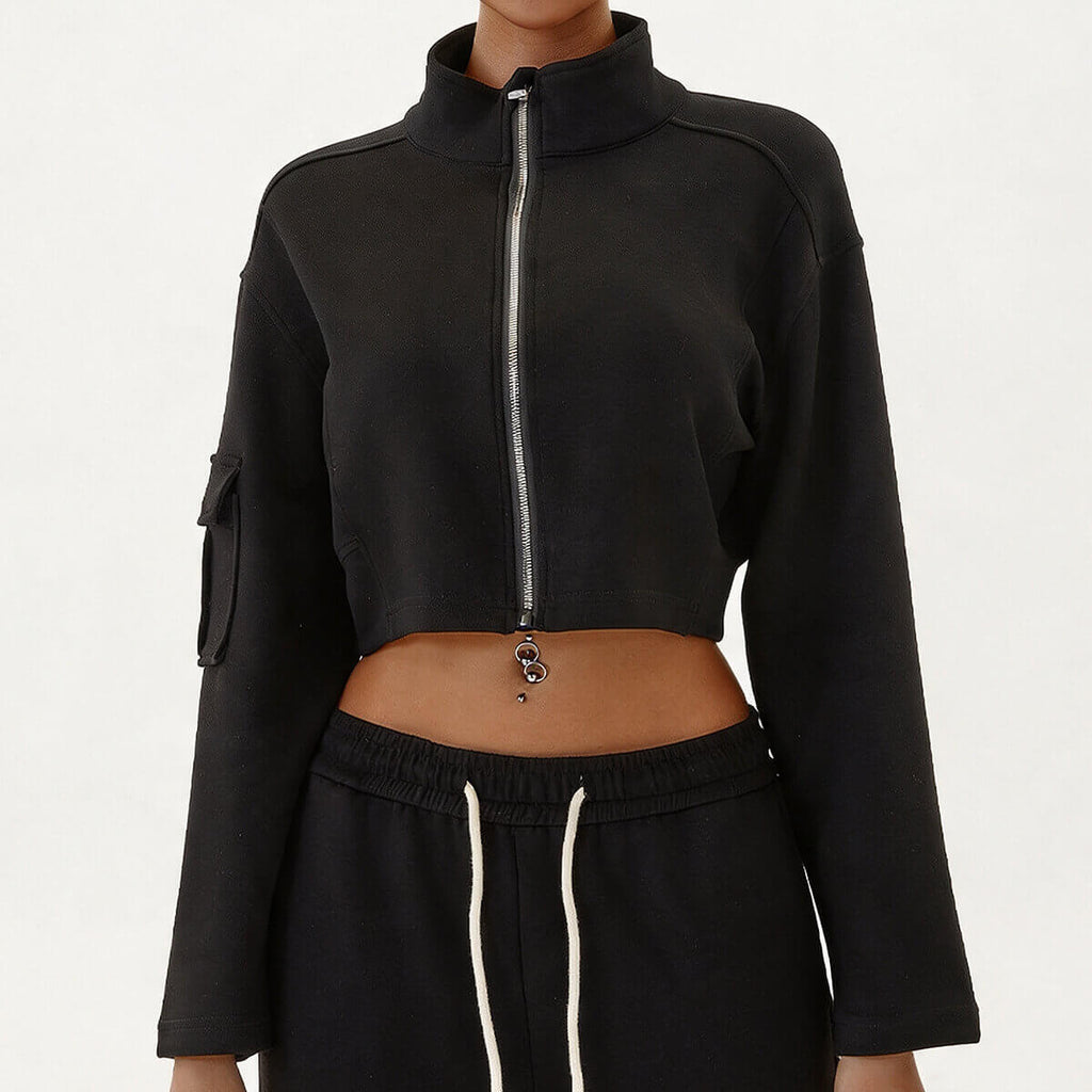 Women's black two-piece streetwear set with a cropped full-zip jacket and high-waisted cargo pants.