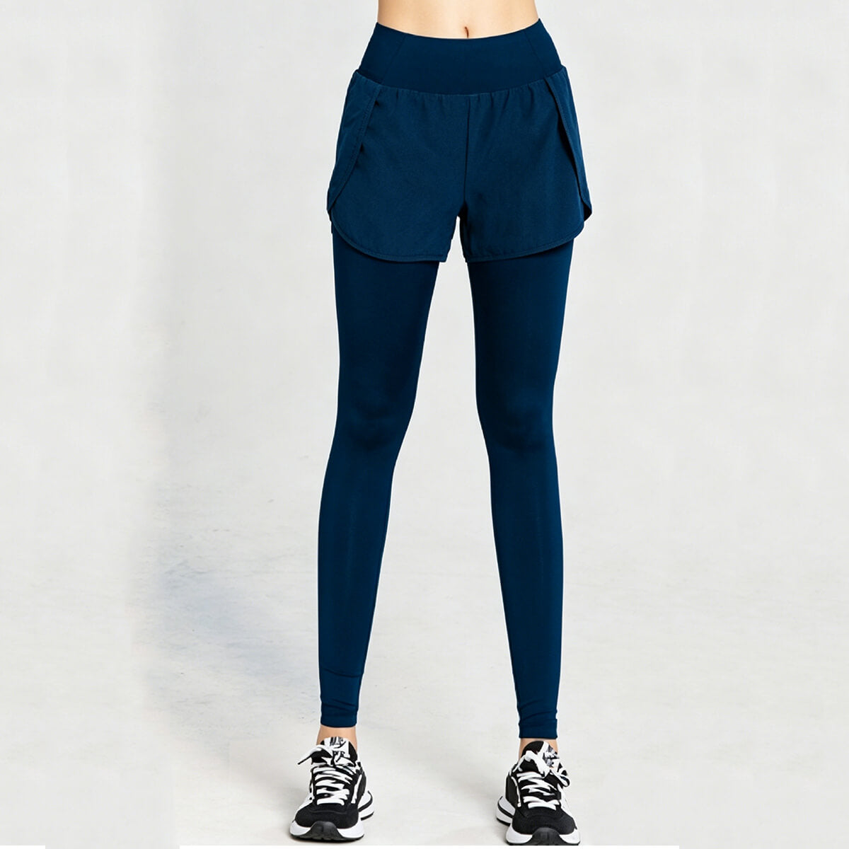 Dark teal double-layer running leggings designed for muscle support and lightweight breathability