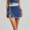 Front view of a navy blue high-waisted tennis skort with light blue contrast piping and built-in shorts for women