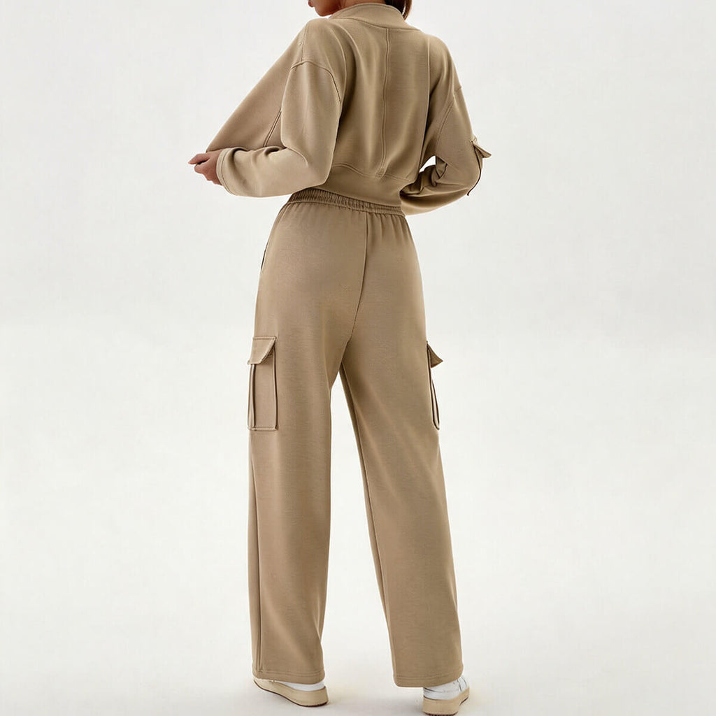 Side and back view of a khaki cargo tracksuit showing the baggy pocket details on the joggers and the cropped fit of the top.