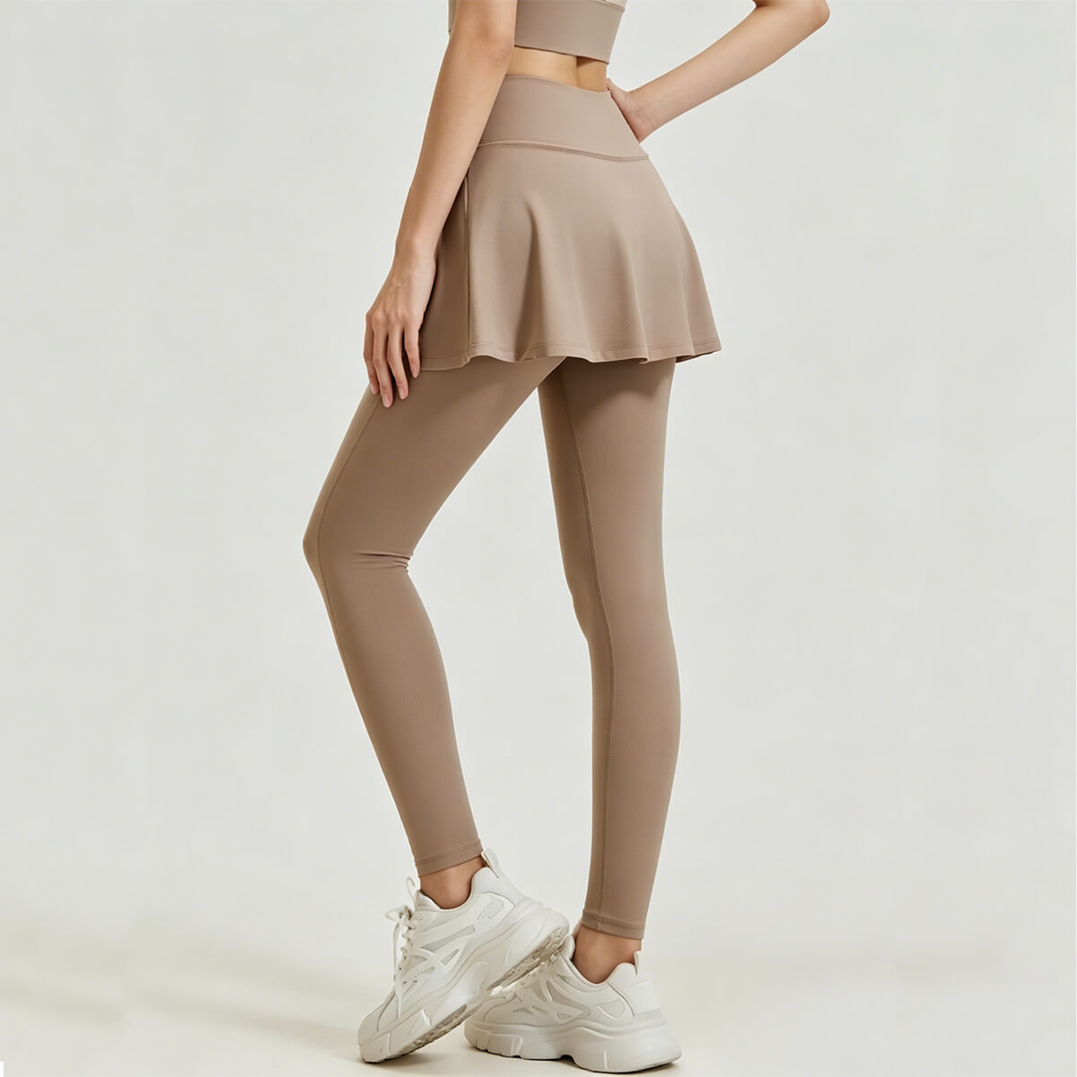 Rear view of khaki fake two-piece fitness leggings highlighting the body-sculpting high-waist cut and premium athletic fabric