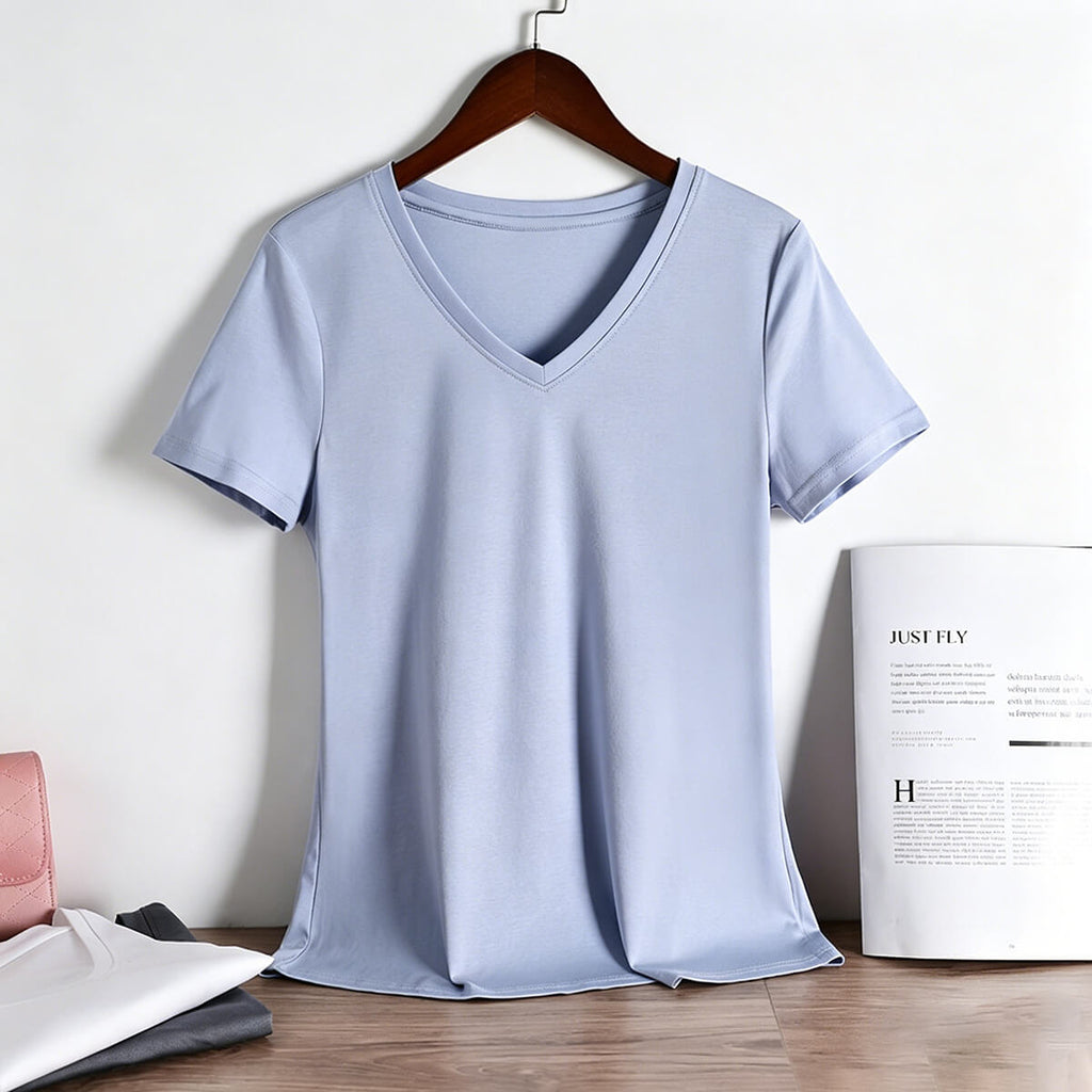 Front view of a light blue women's V-neck T-shirt made of premium 80S long-staple cotton, hanging on a wooden hanger.