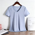 Front view of a light blue women's V-neck T-shirt made of premium 80S long-staple cotton, hanging on a wooden hanger.