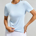 Front view of a light blue women's stretchy workout t-shirt showing the flexible, high-performance fabric for gym training