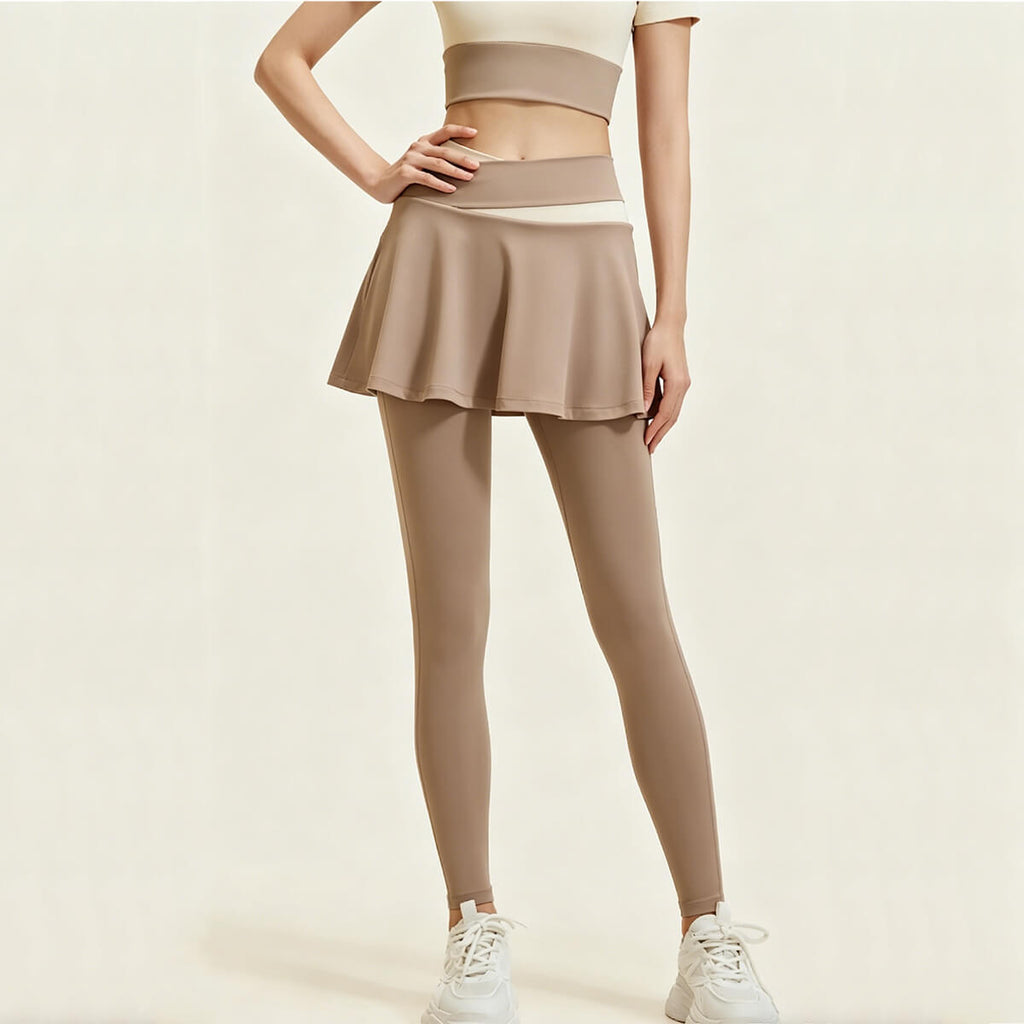 Front view of women's light coffee skirted leggings featuring a high-waisted color-block design and slim-fit yoga pants with a flowy outer skirt