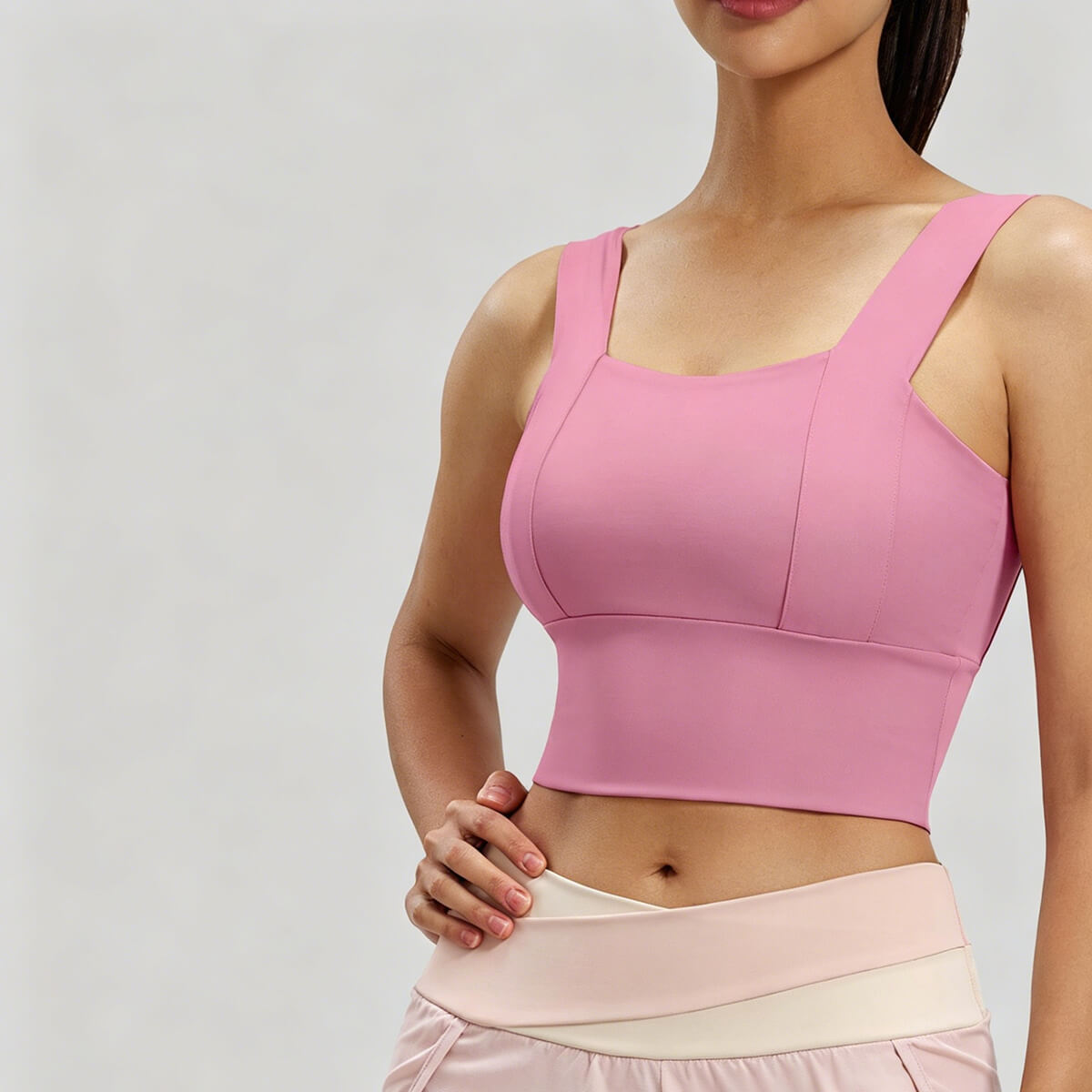 Close-up detail of a mauve pink longline yoga bra featuring a flattering square neckline and high-elasticity fabric