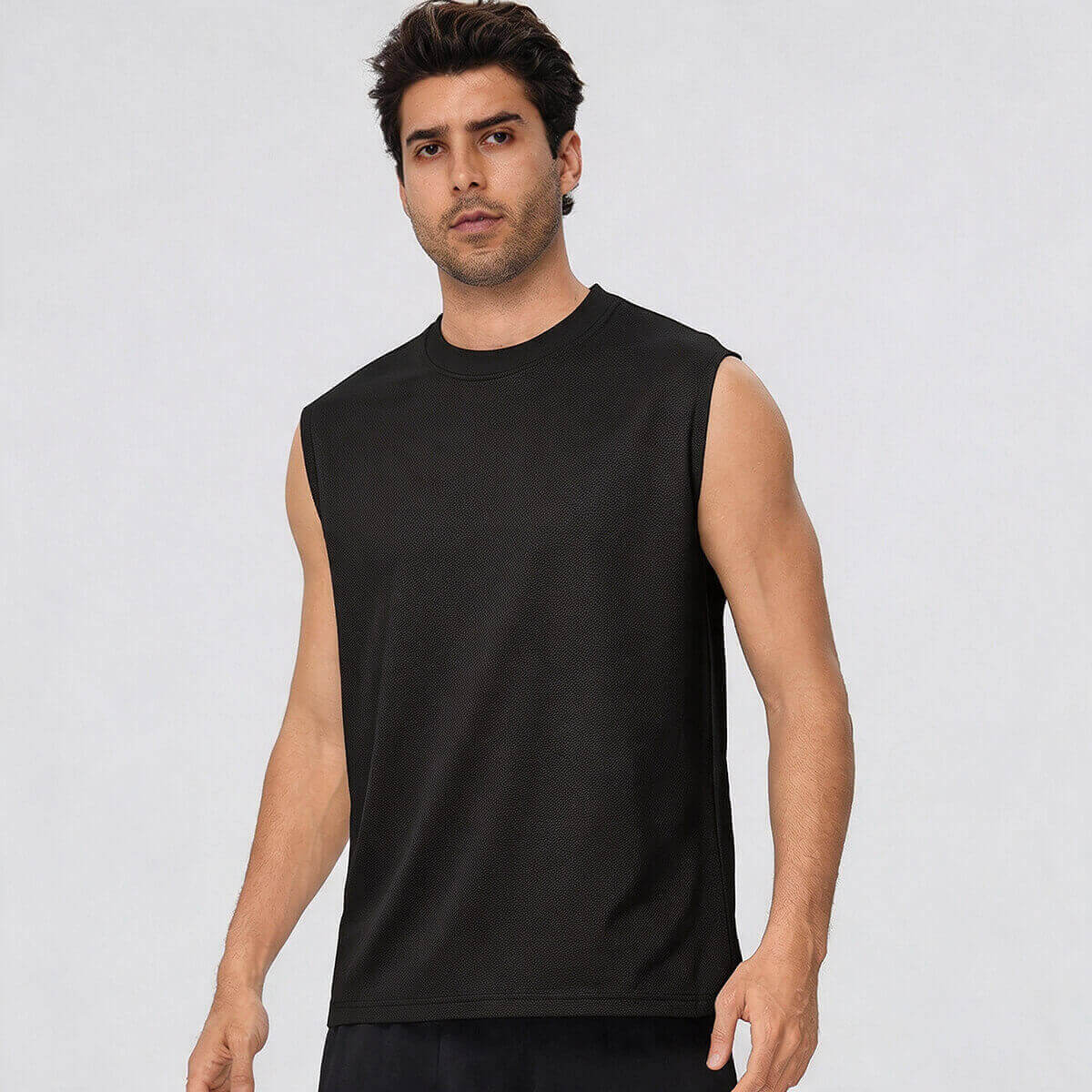Front view of a man wearing a black sleeveless muscle tank top for gym workouts