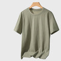 Men's lightweight breathable linen cotton short sleeve shirt in sage green with custom logo, fitness clothing manufacturer - front view.
