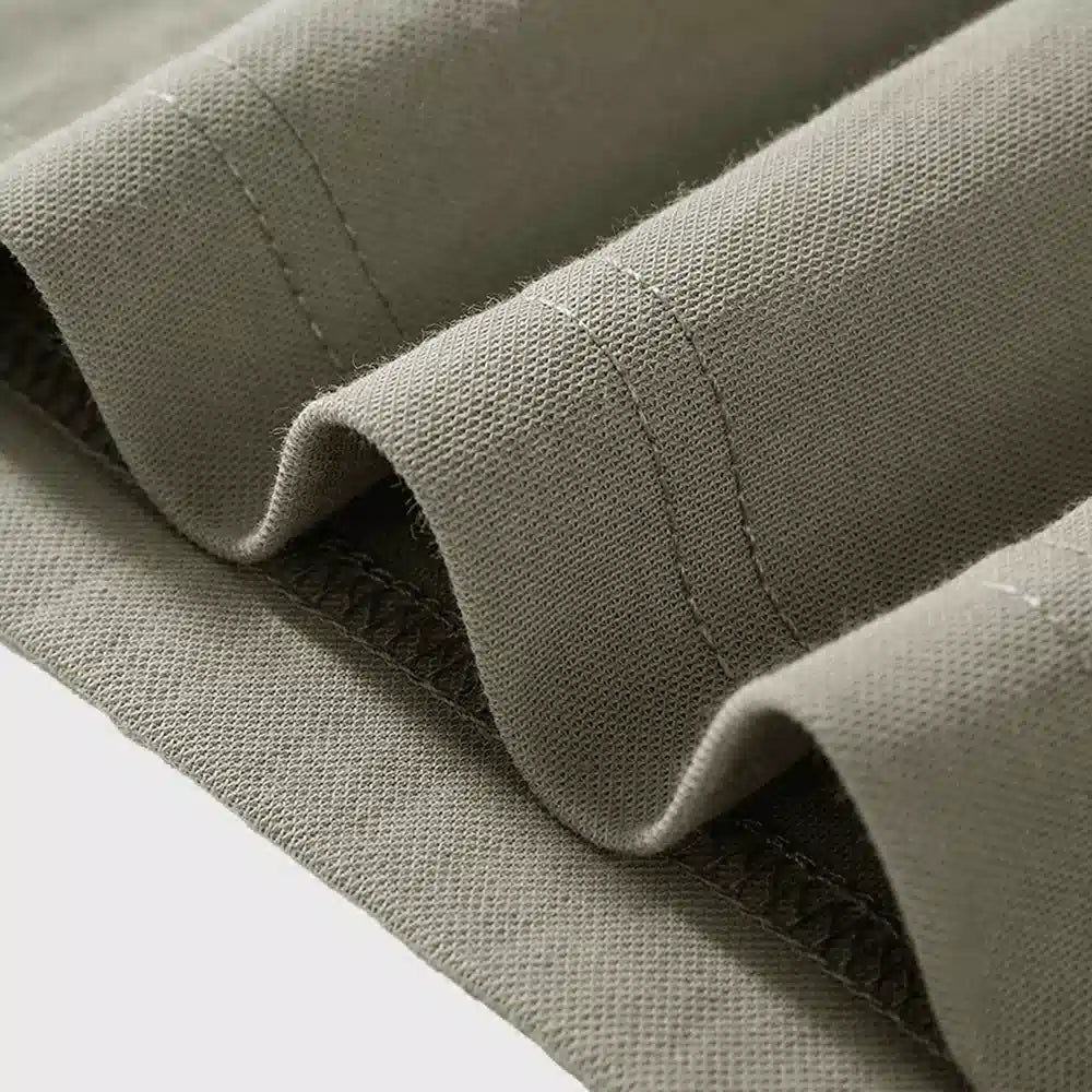 Macro detail of breathable textured linen cotton blend fabric and hem stitching with custom logo, clothing manufacturer.
