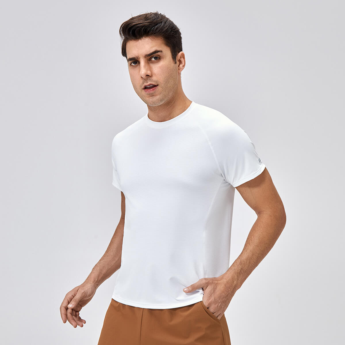 A man wearing a crisp white moisture-wicking athletic top, perfect for summer workouts.
