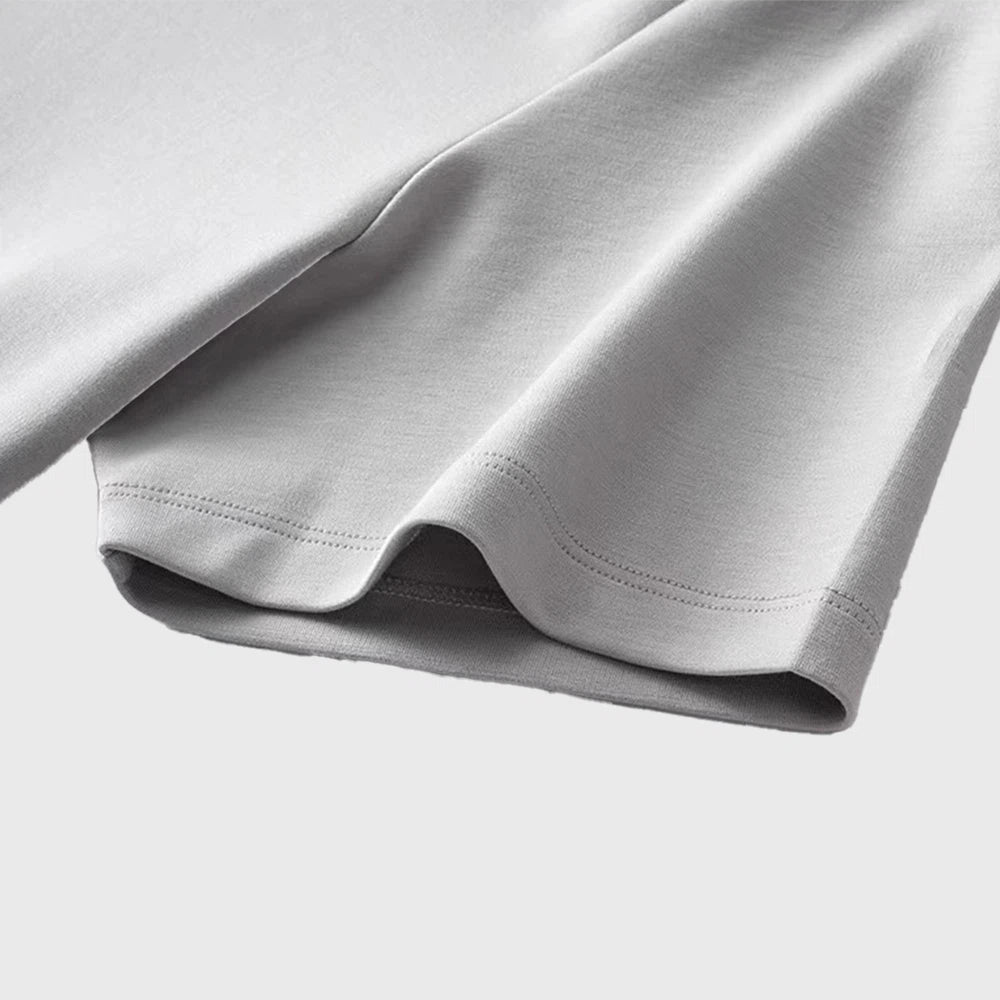 Sleeve cuff stitching and fabric texture detail of men's plain t-shirt with custom logo, crafted by professional OEM manufacturer.