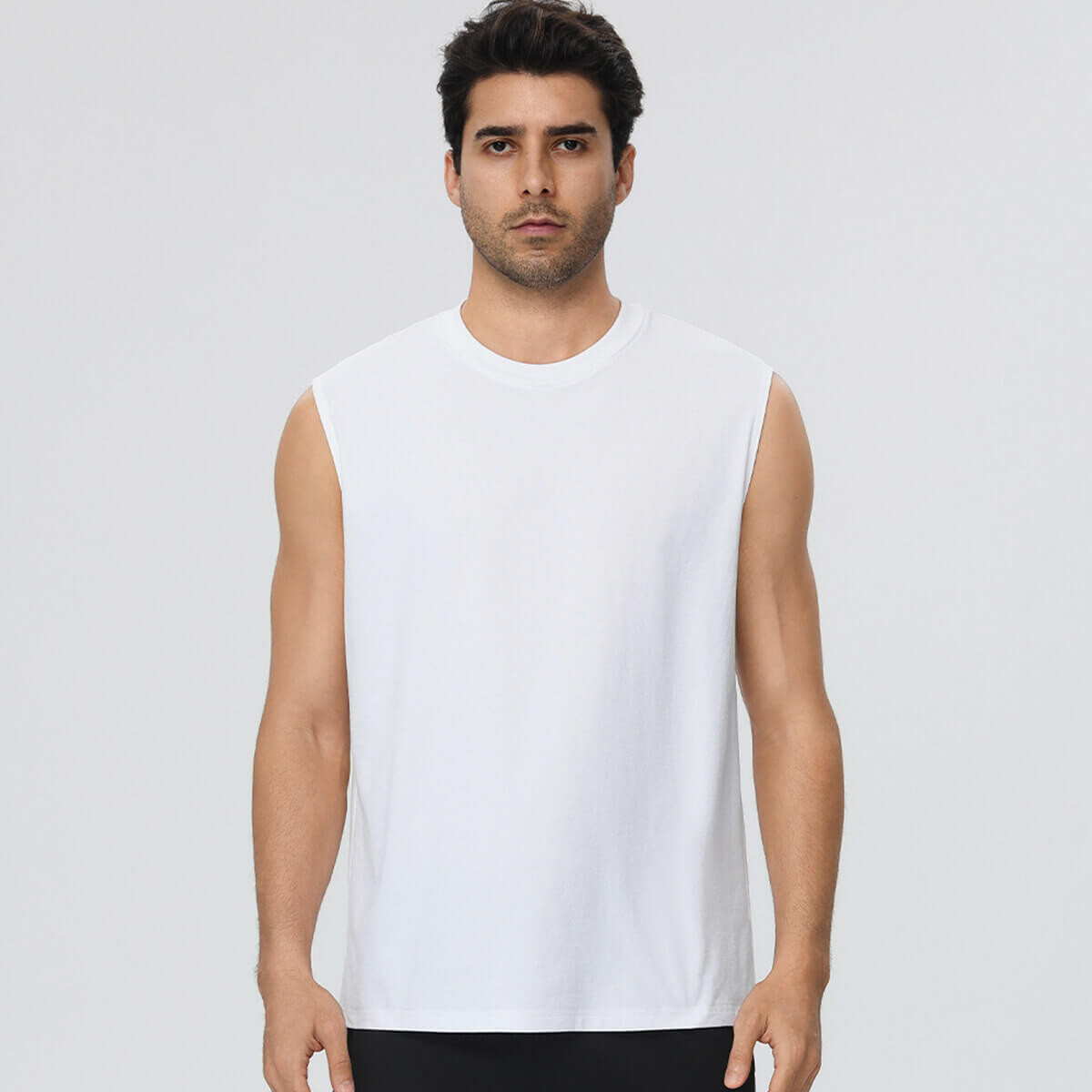 A man in a crisp white sleeveless athletic t-shirt with a crew neck.