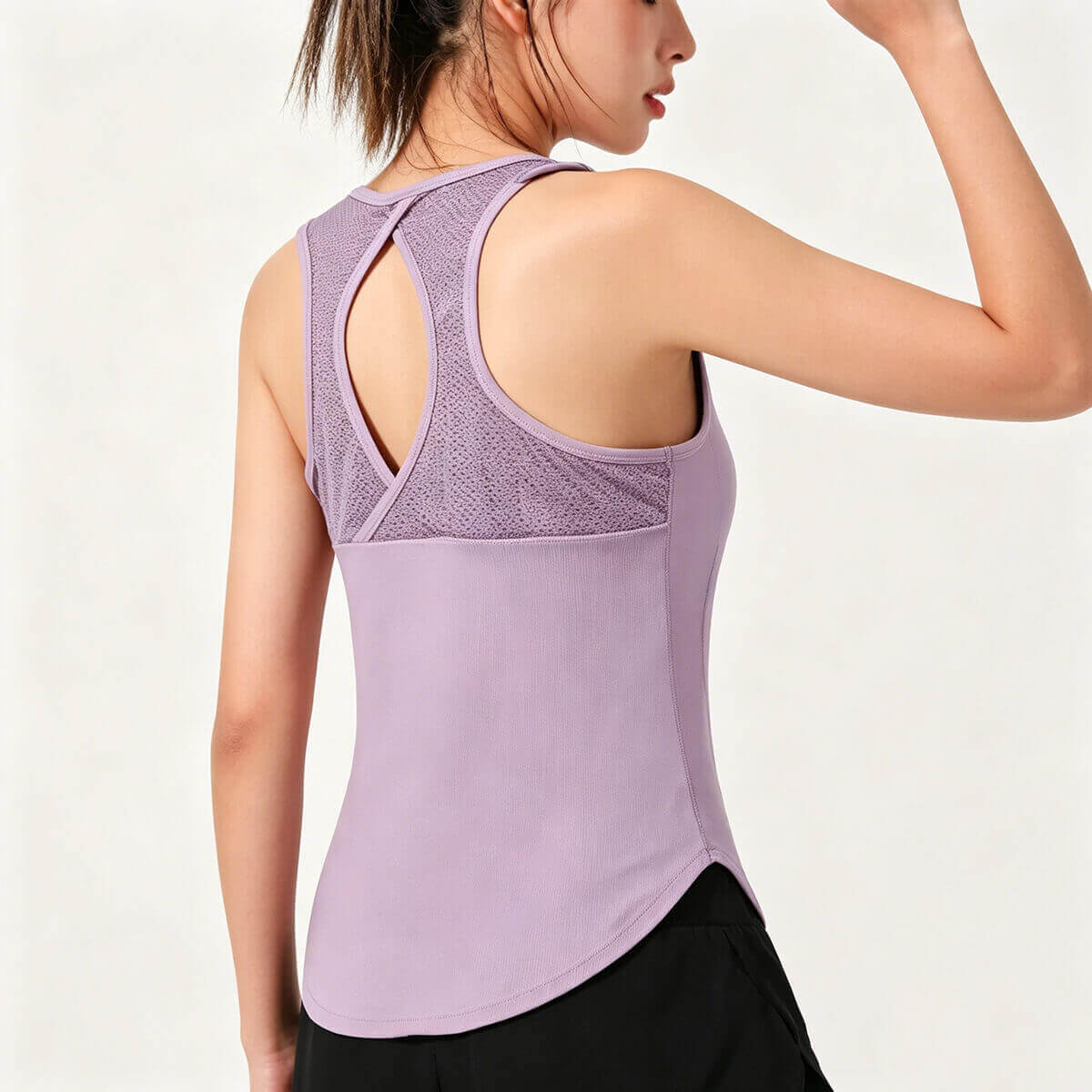 Back view of a purple racerback tank top for women highlighting the breathable mesh cutout and keyhole design