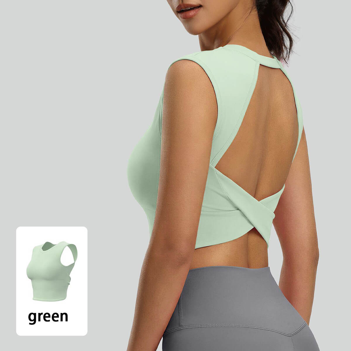 Close-up of a mint green athletic crop top featuring an open back and criss-cross strap detail, perfect for a pastel 90s-inspired workout outfit
