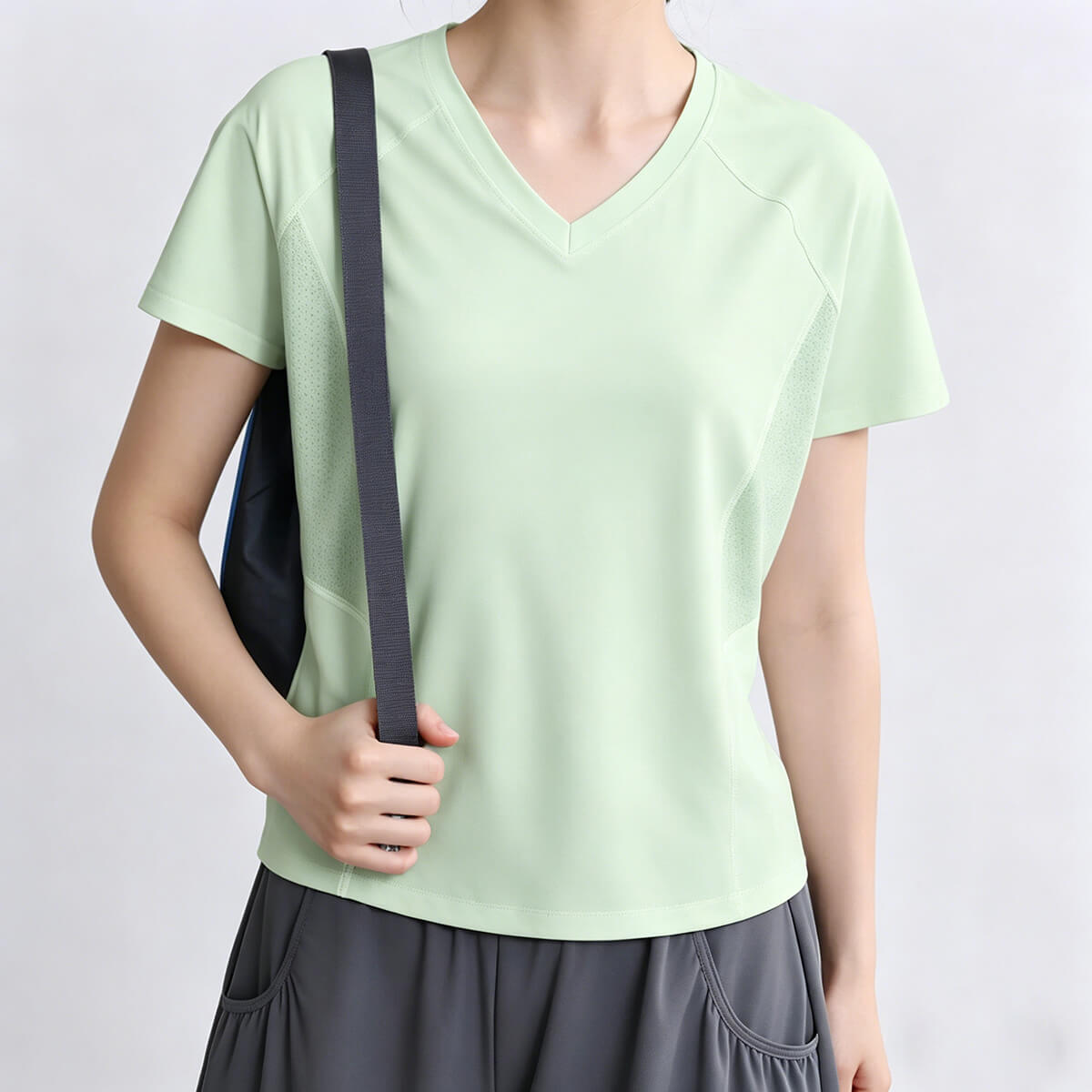 Close-up view of the mint green short sleeve workout tee for women, highlighting the flattering V-neck and lightweight skin-friendly material.