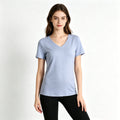 A young female model wearing a light blue 80S premium cotton V-neck T-shirt, demonstrating its flattering and relaxed fit.