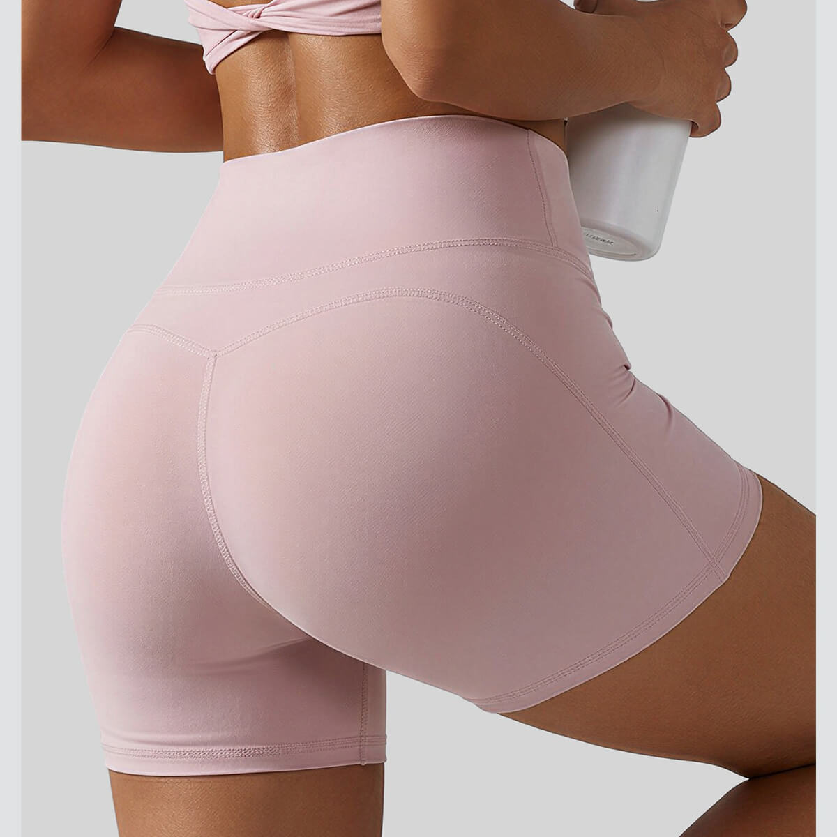 Close-up back view of pink butt-lifting yoga shorts with a V-shaped seam design for an instant peach-lift effect.