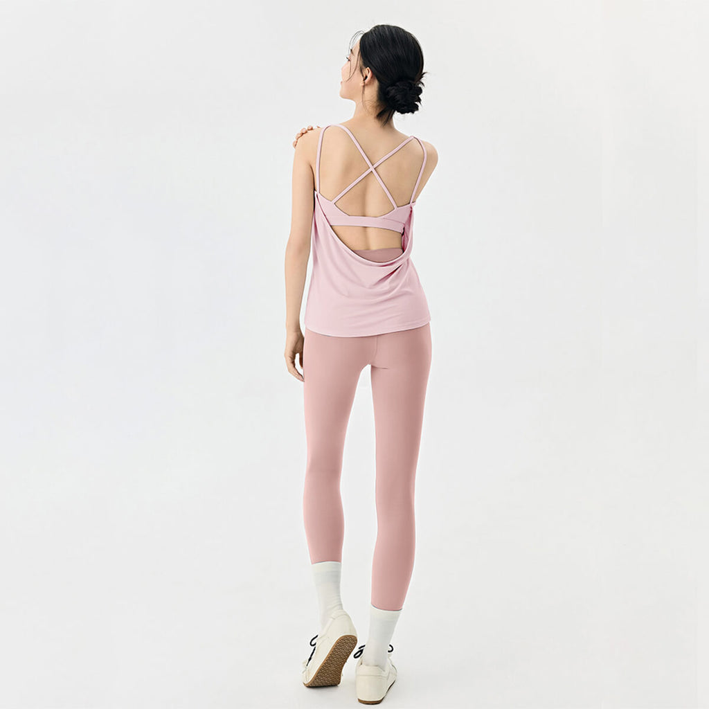 Full back view of a pink moisture-wicking yoga set with high-waisted leggings and an open back tank top.