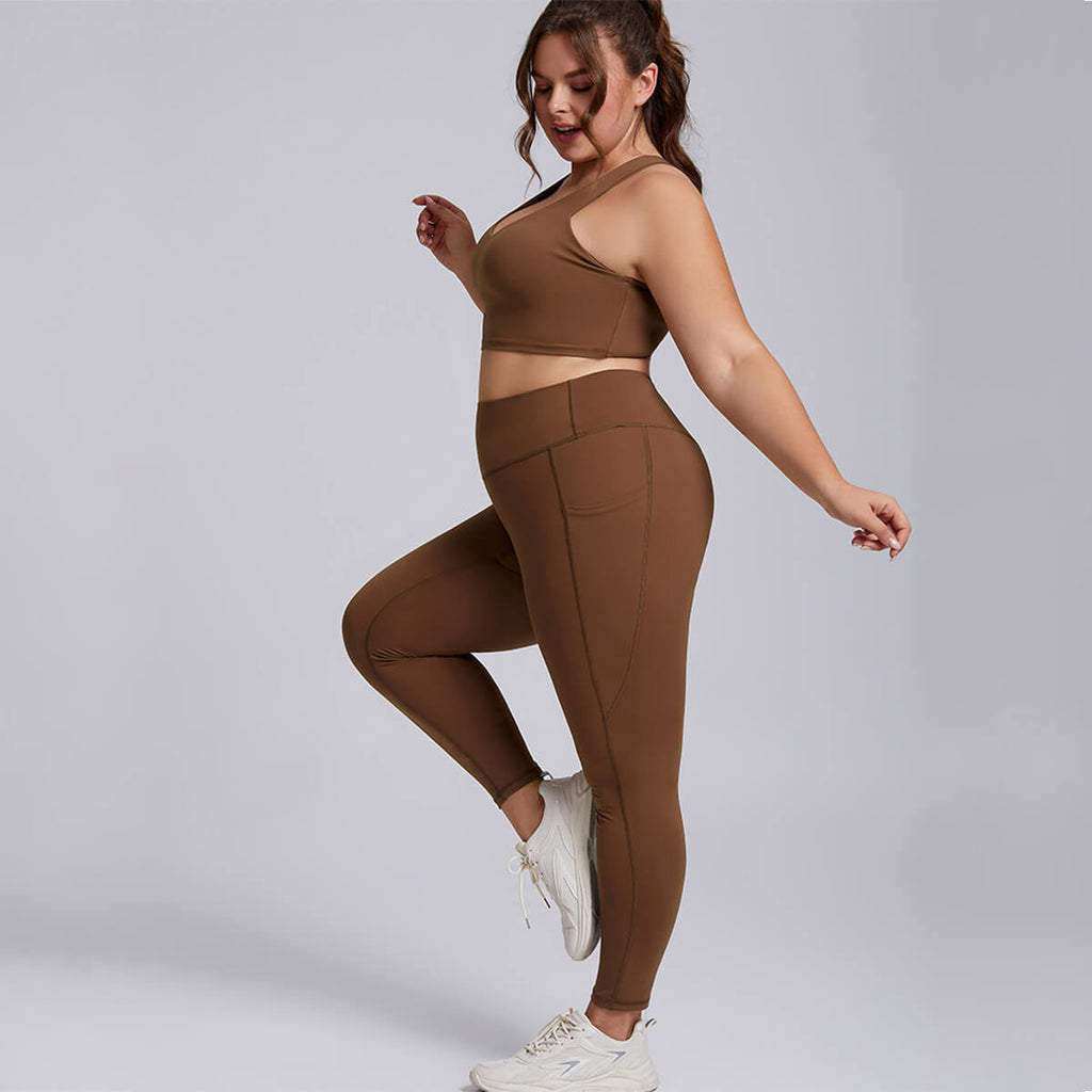 Plus size model wearing a brown matching sports bra and pocket leggings set.