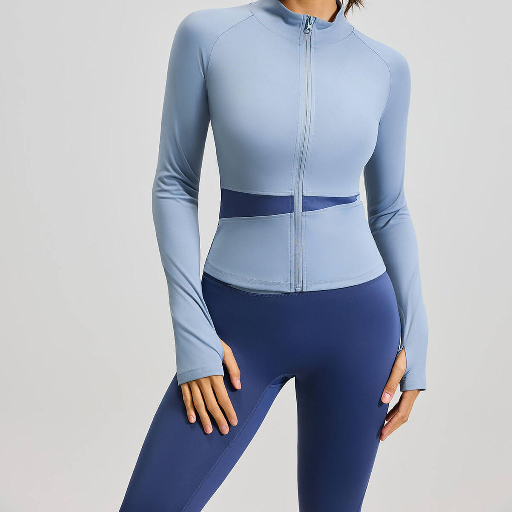 A powder blue women's sports jacket with contrast mesh waist cutouts, ideal for gym training, running, and athleisure style.