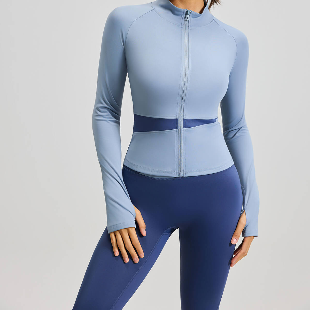 A powder blue women's sports jacket with contrast mesh waist cutouts, ideal for gym training, running, and athleisure style.