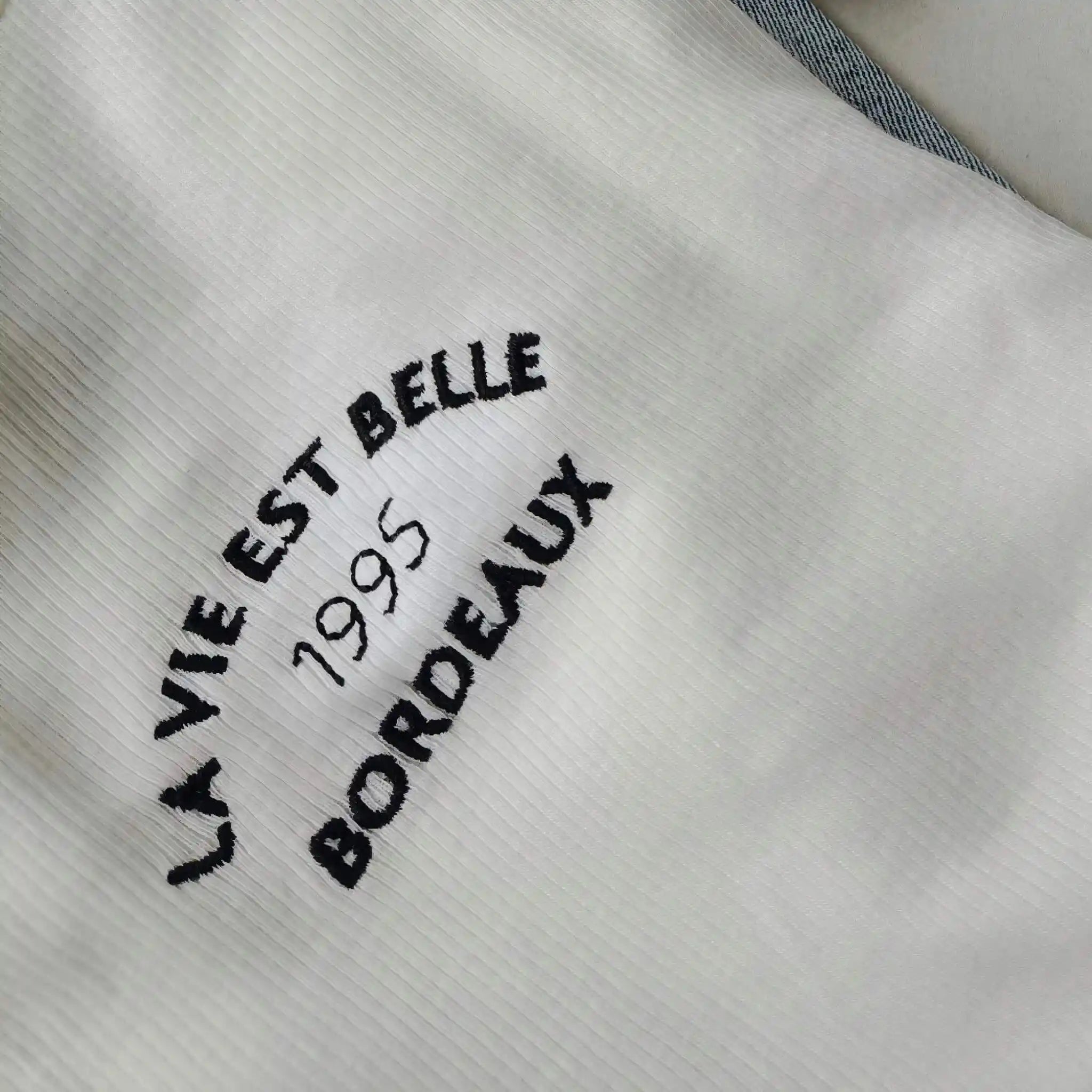 High-quality custom embroidery branding service for fitness jackets, hats, and boutique gym apparel