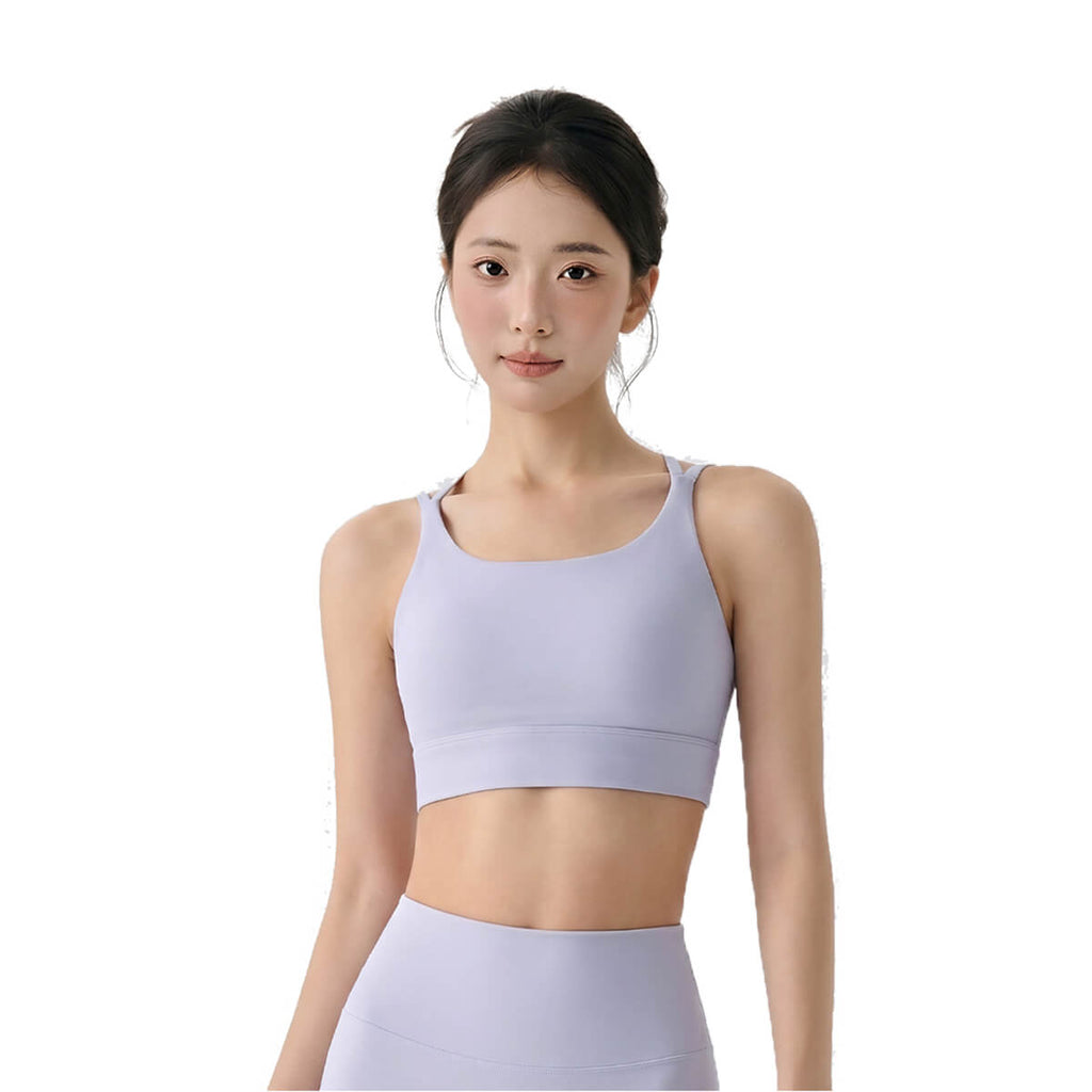 Woman in light purple sports bra and leggings, front view.